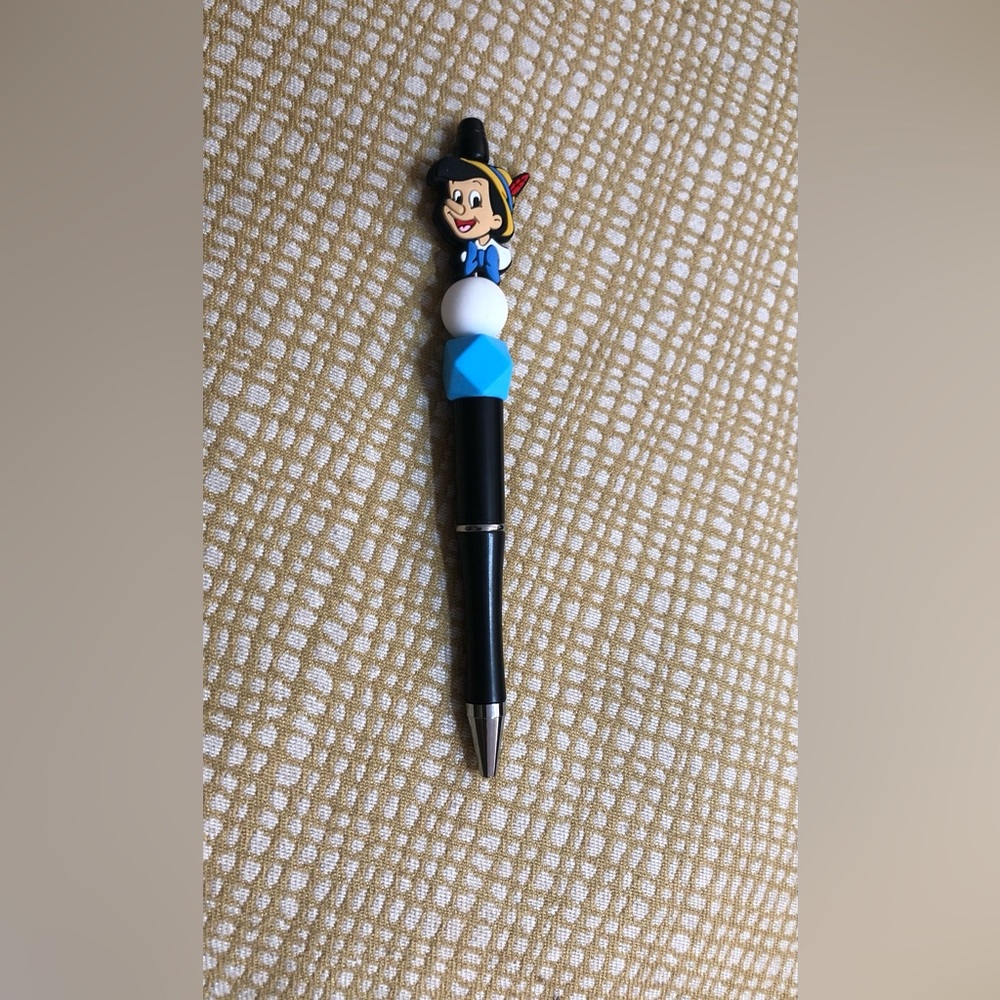 Pinocchio beads pen. Color black. Size 6”LX 1” W